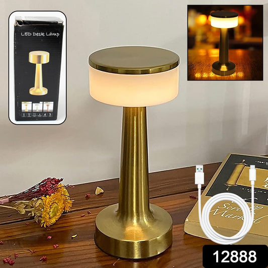 The touch LED lamp casting a warm glow on a bedside table in a bedroom setting.