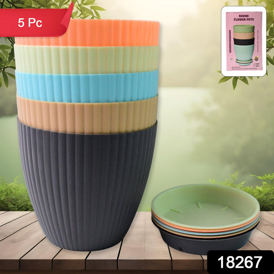 Close-up view of a matte finish round plastic flower pot with subtle stripe details.