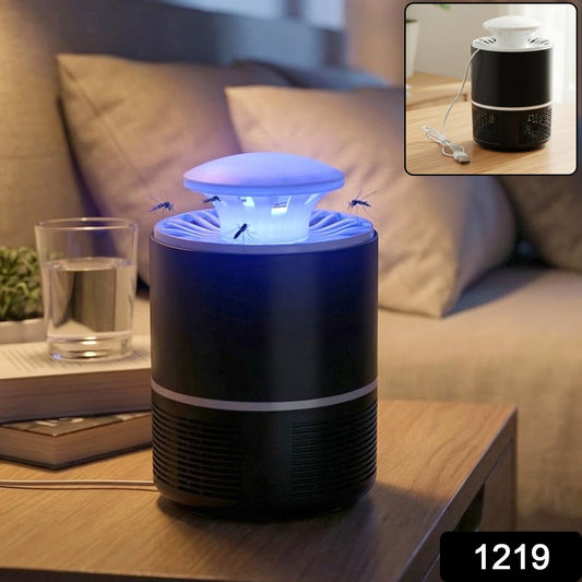 A black and white Mosquito Killer Lamp with a blue light on a wooden nightstand, with a glass of water and a book nearby.