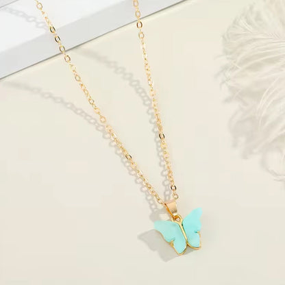 Assorted charm chain necklace with pink hearts and butterflies.