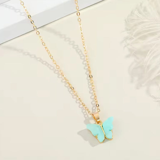 Assorted charm chain necklace with pink hearts and butterflies.