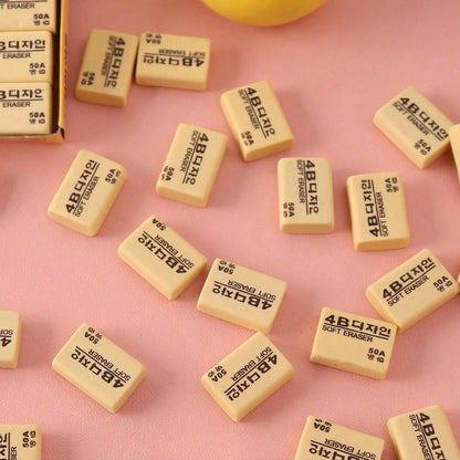 A rectangular bright yellow 4B eraser ready for school or office tasks.