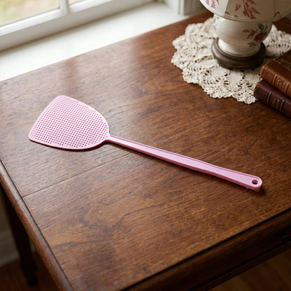 Long handle pest swatter designed for indoor and outdoor use