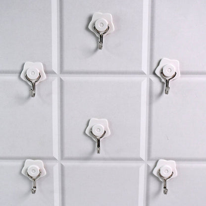 A yellow self-adhesive hook securely holding a towel in a modern bathroom.