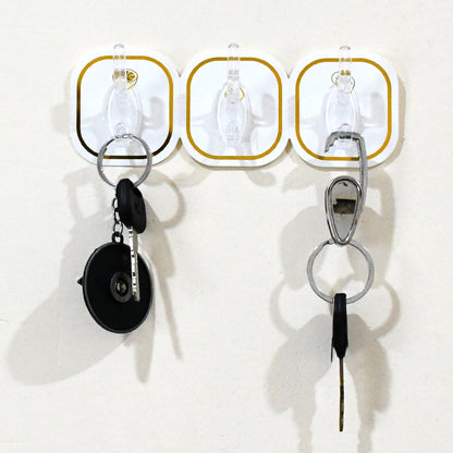 Close-up of a clear plastic transparent adhesive hook with a stainless steel hook.