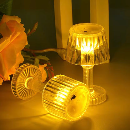 Six decorative LED mini table lamps glowing softly on a dining table setting.