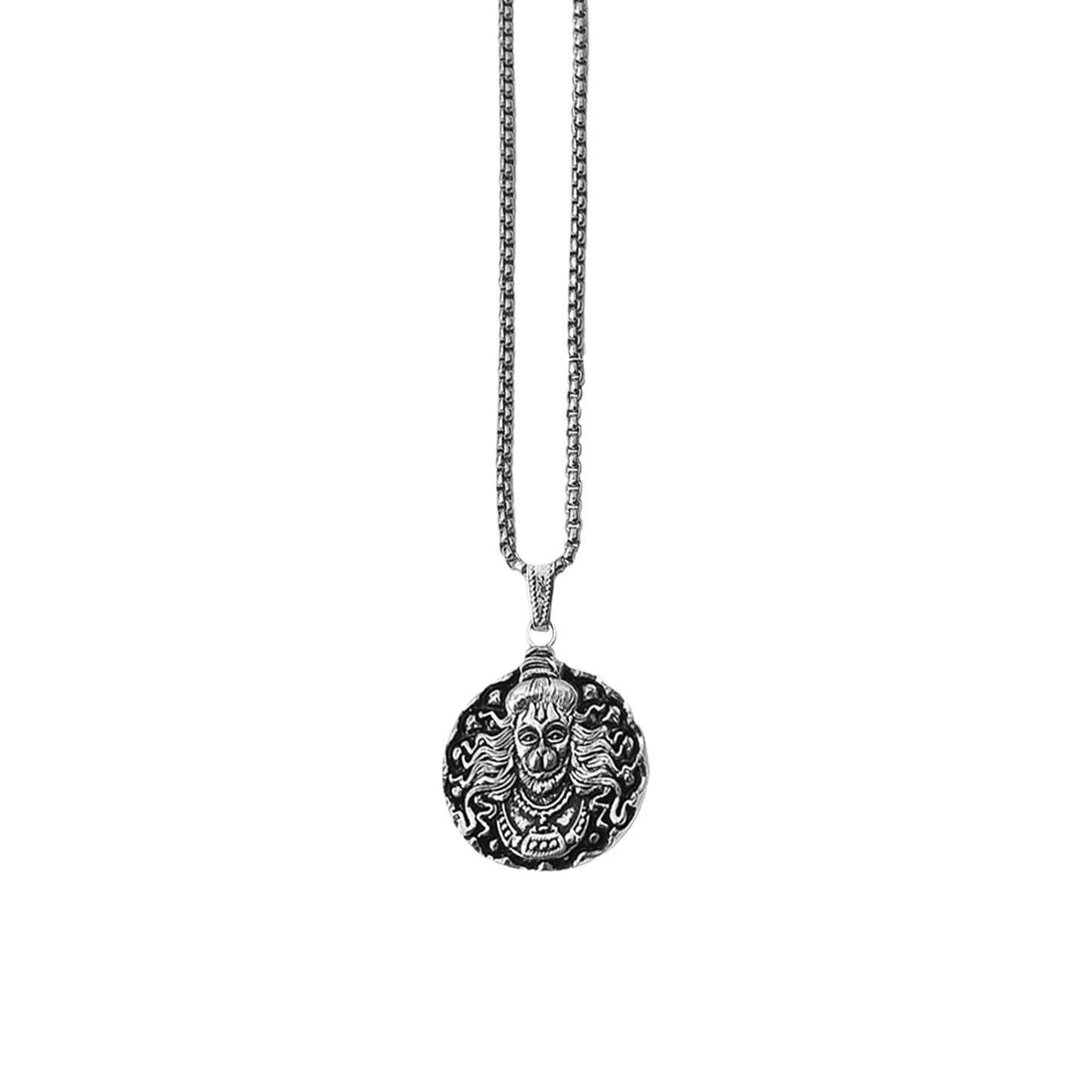 Close-up of a silver Hanuman Locket with intricate details.
