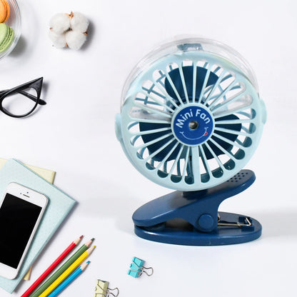 A person using the rechargeable mini fan for personal cooling on a desk.