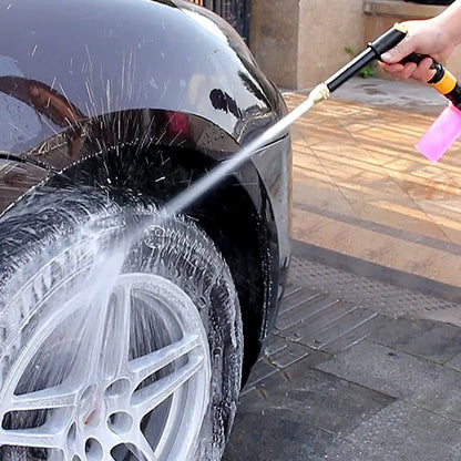 Hand rotating the multi-mode brass spray gun nozzle to select different water patterns.