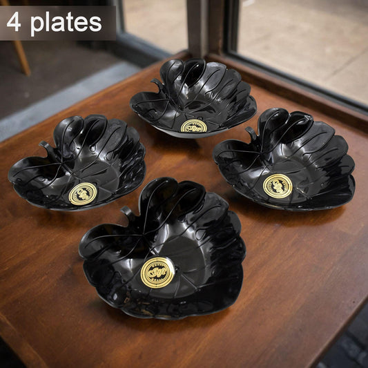 Four ceramic tea cups and four plastic leaf-shaped bowls displayed together.