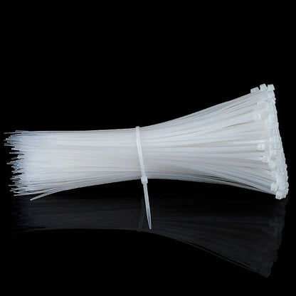 Black nylon cable ties securely holding a group of electrical wires together.