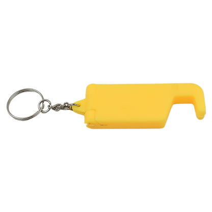 The versatile keychain mobile stand holding a smartphone on a desk.