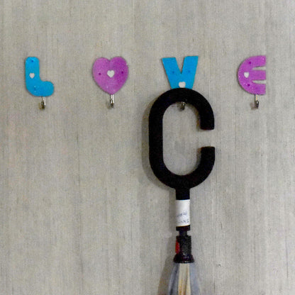 Decorative love shape self adhesive hooks enhancing room aesthetics.