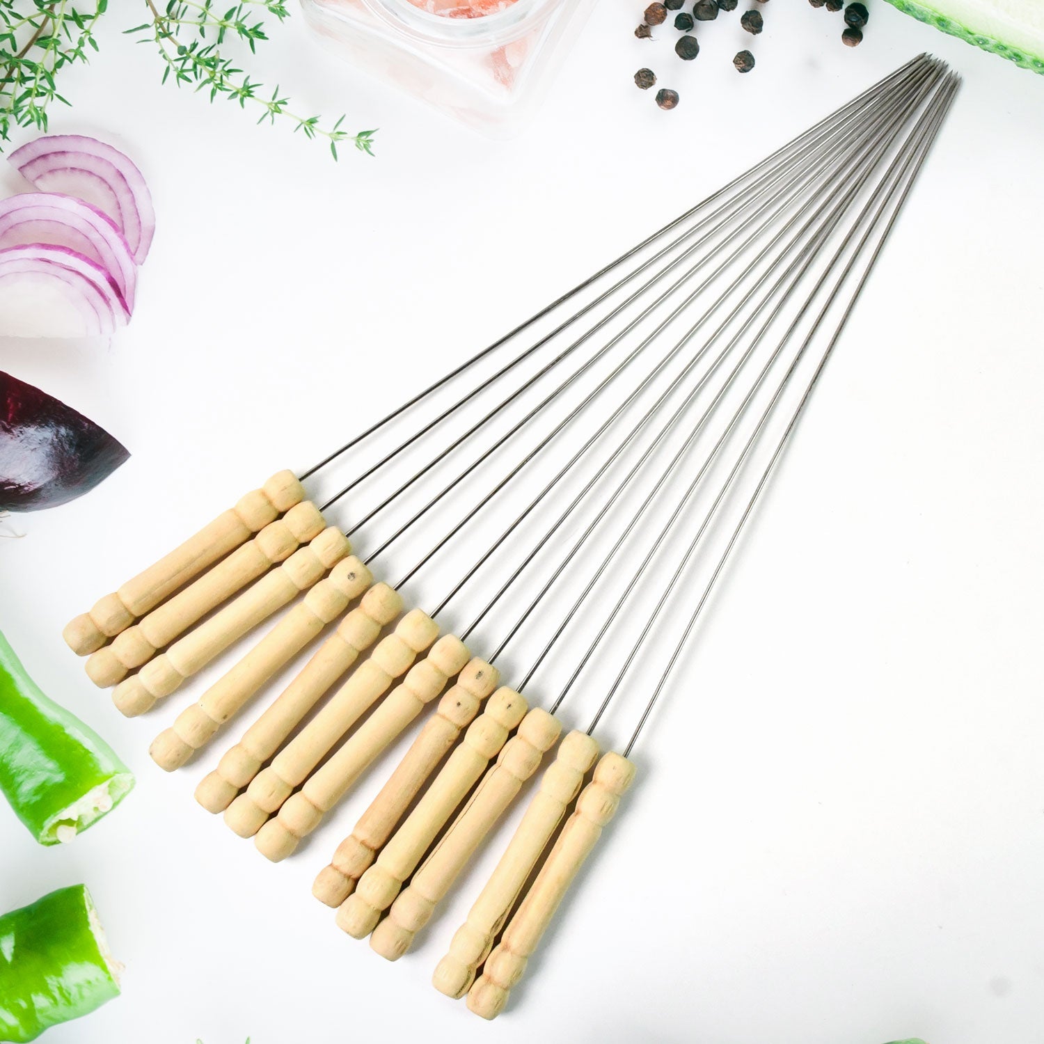 A complete set of 12 stainless steel BBQ skewers with comfortable wooden handles.