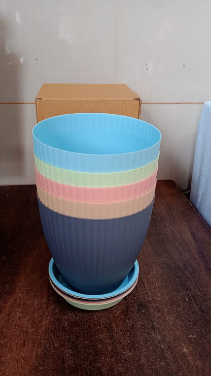An empty black plastic flower pot with its tray, ready for planting and gardening use.