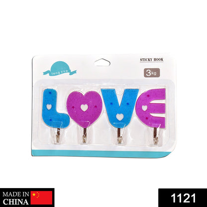 Close-up of heart-shaped wall hooks in white for home organization.
