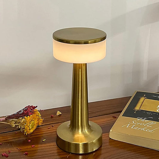 A sleek, modern portable LED desk lamp illuminating a contemporary workspace.