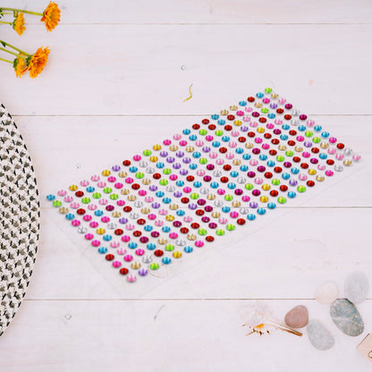 Assorted sparkling crystal stickers applied to a phone case and other craft items.