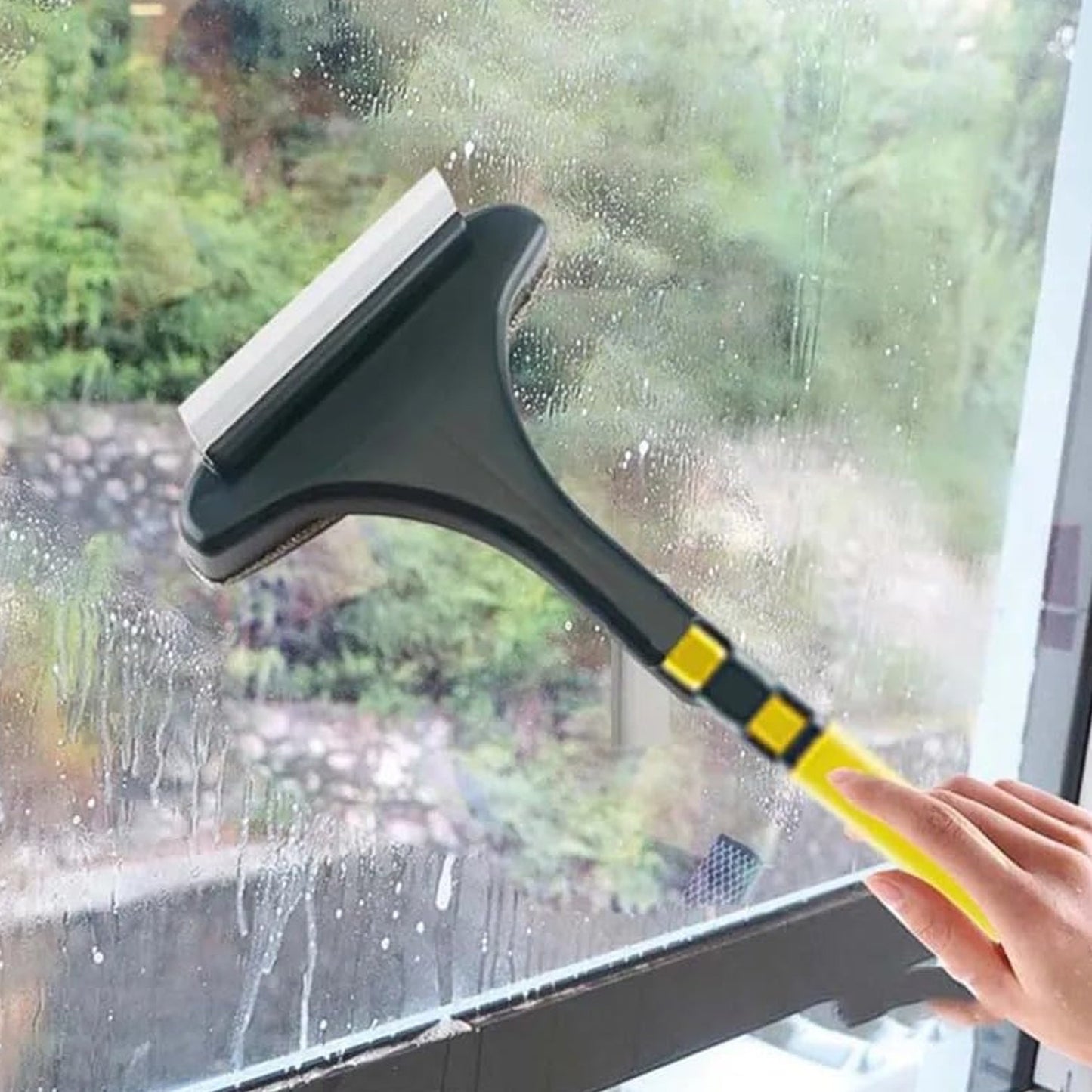 2-in-1 mesh and glass window cleaning brush with extended handle shown in use.