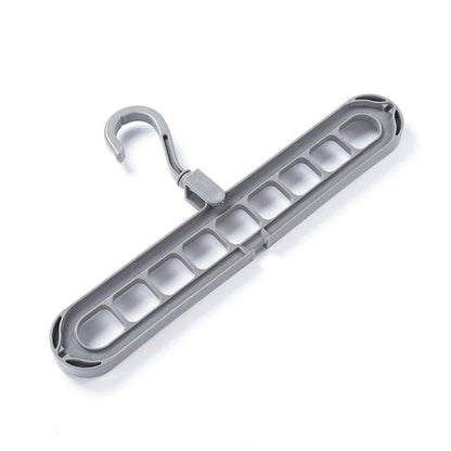 Several shirts and trousers neatly hung on the innovative 9-hole space saving hanger.