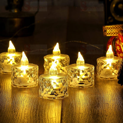 Multiple acrylic flameless tea lights glowing warmly in a home setting.