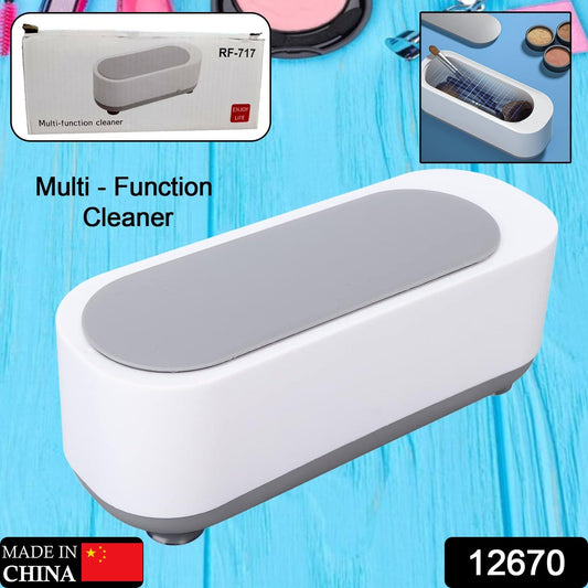 Ultrasonic jewellery cleaner actively cleaning a watch and several rings.