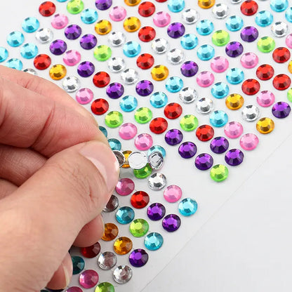 Shining stone stickers being applied to a mobile phone and other craft items.
