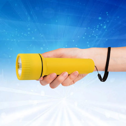 The yellow plastic torch with a black wrist strap stands upright on a dark, textured surface.