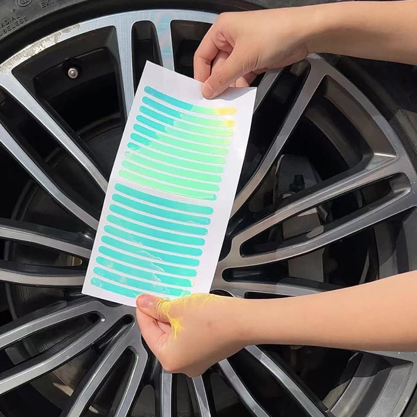 Set of colorful car wheel stickers laid out, showing their reflective surface.