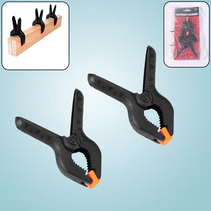 Close-up of a pair of heavy-duty spring clamps for mobile device screen repair.