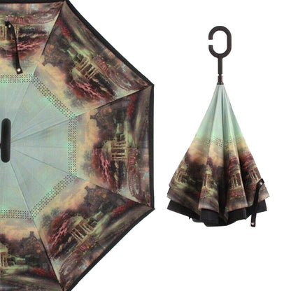 A reverse umbrella with a dark landscape painting on its inner surface, shown both partially open and closed.