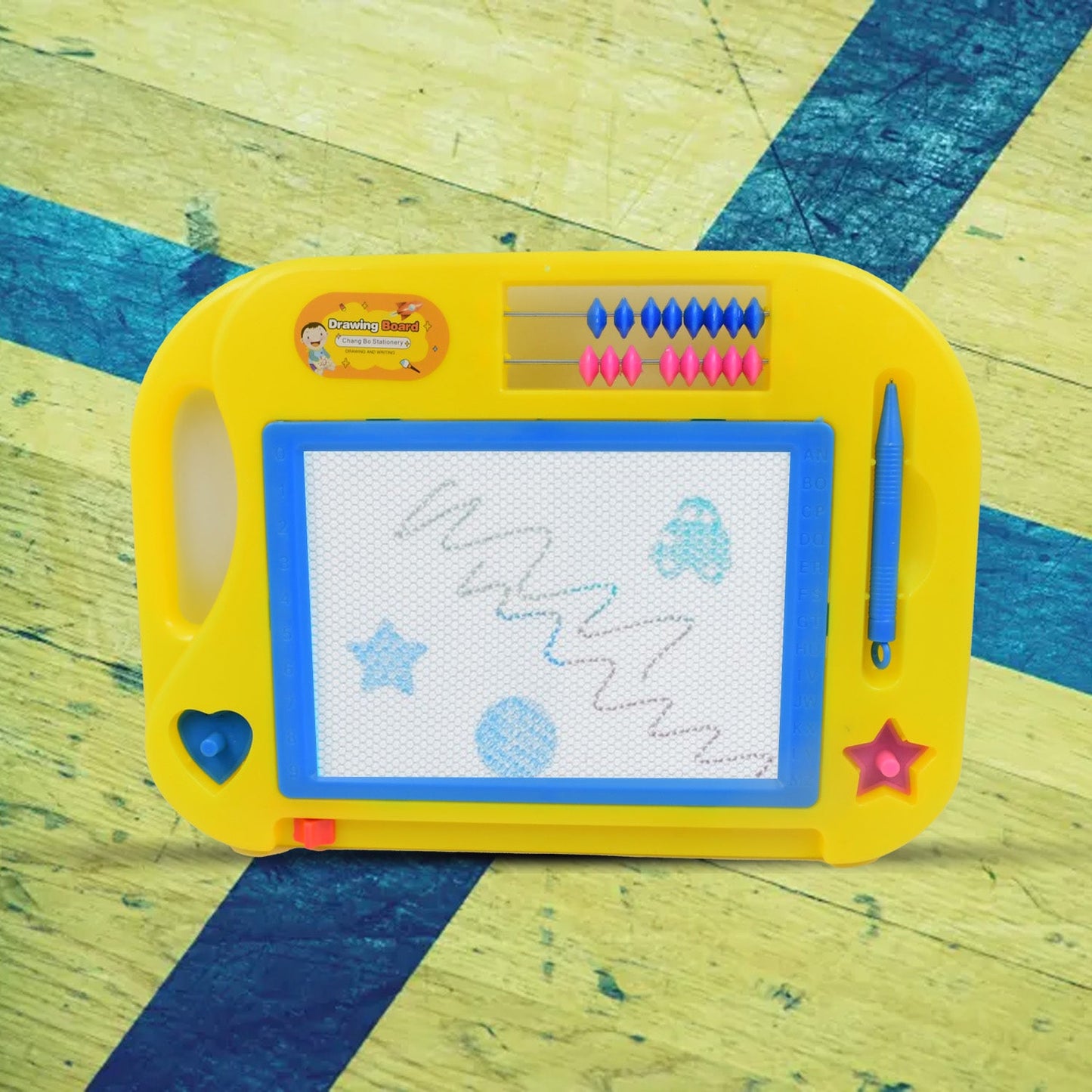 Close-up of a child drawing on the Magic Sketch Slate with the attached stylus pen.