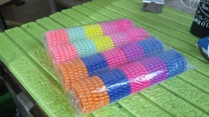 Various telephone wire hair bands in different colors arranged together.