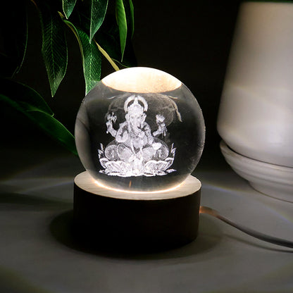 Detailed view of the illuminated 3D Ganpati idol inside the crystal ball, showing its radiant effect.