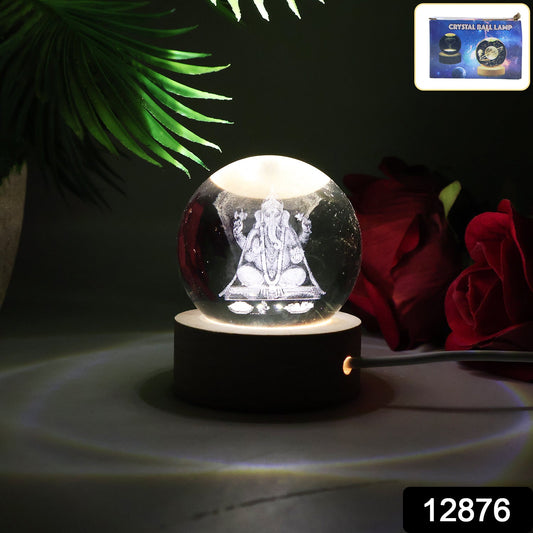 Ganesha 3D Crystal Ball Lamp illuminating a desk, showcasing its intricate design.