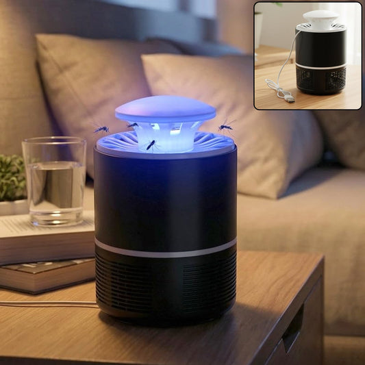 A black and white Mosquito Killer Lamp with a blue light on a wooden nightstand, with a glass of water and a book nearby.