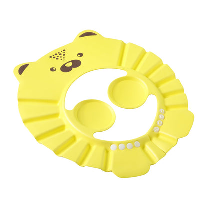 A toddler smiles while wearing a bath shower cap with a fun cartoon design, ensuring happy baths.