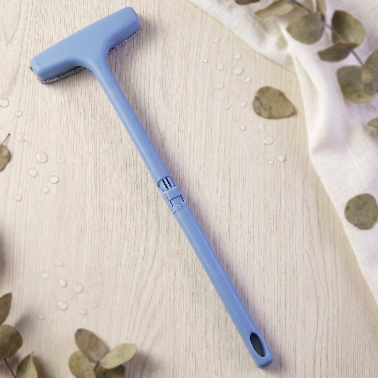 The soft bristles of the window mesh cleaner gently cleaning delicate screen surfaces.